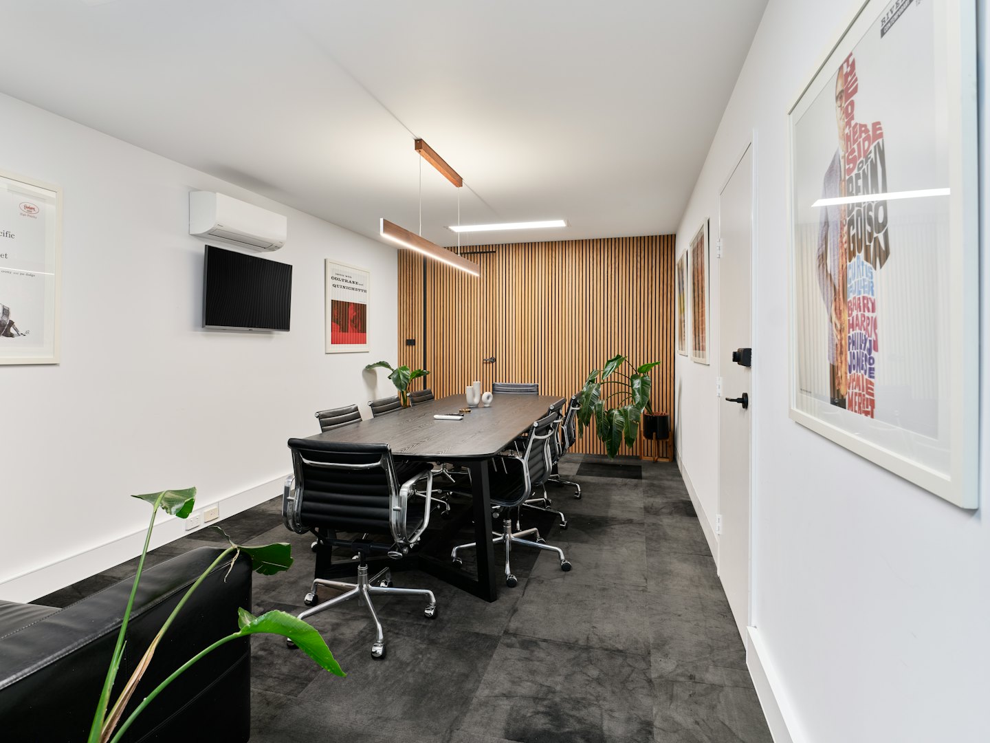 Modern office meeting room with a long conference table.